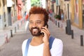 Ethnic exotic male calling by phone outdoors