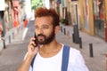 Ethnic exotic male calling by phone outdoors