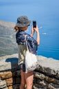 Ethnic female tourist with phone camera on table mountain South Africa Royalty Free Stock Photo