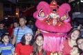 Ethnic Filipino Chinese Pose with Dancing Lion Mascot during New Year Celebration on the street