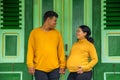 Ethnic Indonesian couple during pregnancy in front of traditional house Royalty Free Stock Photo