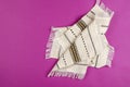 Ethnic kitchen napkin with fringe on a pink background