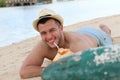 Ethnic male drinking a fresh coconut at the beach Royalty Free Stock Photo