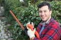 Ethnic male gardener smiling at work