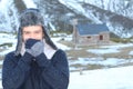 Ethnic man showing with a hand-face gesture that is freezing outside