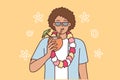 Ethnic man tourist from island of Hawaii drinks coconut cocktail and invites to beach party Royalty Free Stock Photo