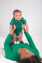 Ethnic mother playing with her baby boy son on bed Royalty Free Stock Photo