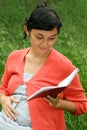 Ethnic pregnant woman read medical report