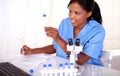 Ethnic scientific woman working with test tube