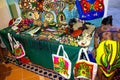 Ethnic souvenirs, baseball caps, bags with various pattern hanging in street market