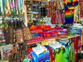 Ethnic souvenirs, baseball caps, bags with various pattern hanging in street market