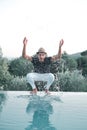 Ethnic Stylish young man splashing water near a swimming pool Royalty Free Stock Photo