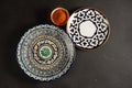 Ethnic Uzbek ceramic tableware on the black background.
