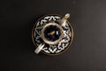 Ethnic uzbek ceramic tableware on a black background.