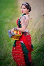 Ethnic woman with apples on grass