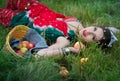 Ethnic woman with apples on grass Royalty Free Stock Photo