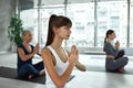 Ethnic woman with mudra hands meditate at yoga class