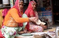 The ethnic woman preparing the cake to pies chapati. Pushkar, India