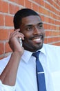 Ethnic Young Businessman Outside Office On Mobile Phone Royalty Free Stock Photo