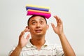 Ethnic young man balancing books on head Royalty Free Stock Photo