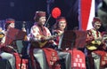 Ethno orchestra performing, women in a Ukrainian native dress playing string instruments