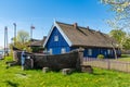 Beautiful old Lithuanian traditional wooden house with thatched roof and boat Royalty Free Stock Photo