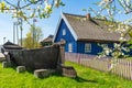 Beautiful old Lithuanian traditional wooden house with thatched roof and boat Royalty Free Stock Photo