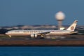 Etihad Airways Boeing 777 landing at Sydney Airport just after sunset