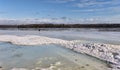 Etna Pond in Maine frozen with a chair sitting on the ice on a chilly winter day