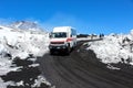 Etna, Sicily, Italy - Apr 9th 2019: Tourist jeep or bus driving tourists to the top of Etna volcano and back. Snow on the volcanic