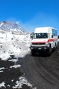 Etna, Sicily, Italy - Apr 9th 2019: Tourist vehicle driving people to the top of Mount Etna and back. Snow on the volcanic land