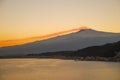 The Etna volcano at sunset over the bay of Taormina