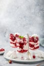 Eton mess, traditional english dessert, meringues, whipped cream, berry sauce and fresh raspberry in  glass Royalty Free Stock Photo