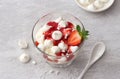 Eton mess, traditional English dessert, strawberry with cream, meringue and strawberry sauce on light gray textured background Royalty Free Stock Photo