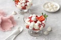 Eton mess, traditional English dessert, strawberry with cream, meringue and strawberry sauce on light gray textured background Royalty Free Stock Photo