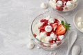 Eton mess, traditional English dessert, strawberry with cream, meringue and strawberry sauce on light gray textured background Royalty Free Stock Photo