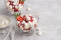 Eton mess, traditional English dessert, strawberry with cream, meringue and strawberry sauce on light gray textured background Royalty Free Stock Photo