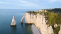 Etretat, Normandy, France. Cliffs Aval and Needle with beautiful famous coastline during the tide at sunset. Aerial view