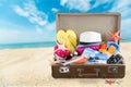 Etro suitcase with travel objects on tropical Royalty Free Stock Photo