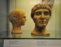 Etruscan terracotta votive half-head of a girl and a man exhibited at the British Museum in London, United Kingdom