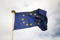 Single european flag against a cloudy summer sky