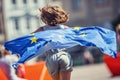 EU Flag. Cute happy girl with the flag of the European Union. Young teenage girl waving with the European Union flag in the city Royalty Free Stock Photo