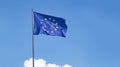 EU flag flying against blue sky with copyspace