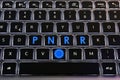 EU Flag and words \'PNRR\' on the buttons of backlight keyboard of laptop.
