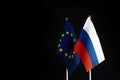 EU and Russia flags on black background. Sanctions pressure, politics concept photo. Europe union vs Russia. Copy space