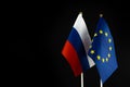 EU and Russia flags on black background. Sanctions pressure, politics concept photo. Europe union vs Russia. Copy space