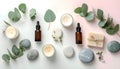 Aromatherapy oils and eucalyptus leaves flat lay, soft pastel tones background Royalty Free Stock Photo