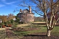 Eucalyptus tree in the foreground of a historical home Royalty Free Stock Photo