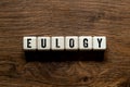 Eulogy - word concept on building blocks , text