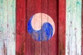 Eum and Yang Symbol, korean style of Yin and Yang. Colorful retro painting with red background on a wooden door